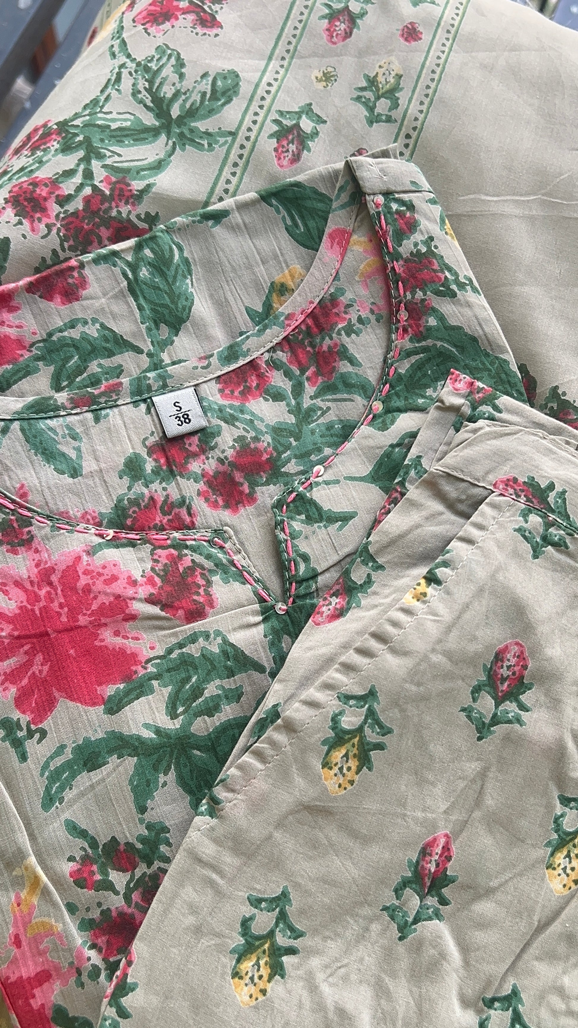 Floral patterned fabric with a visible brand label.