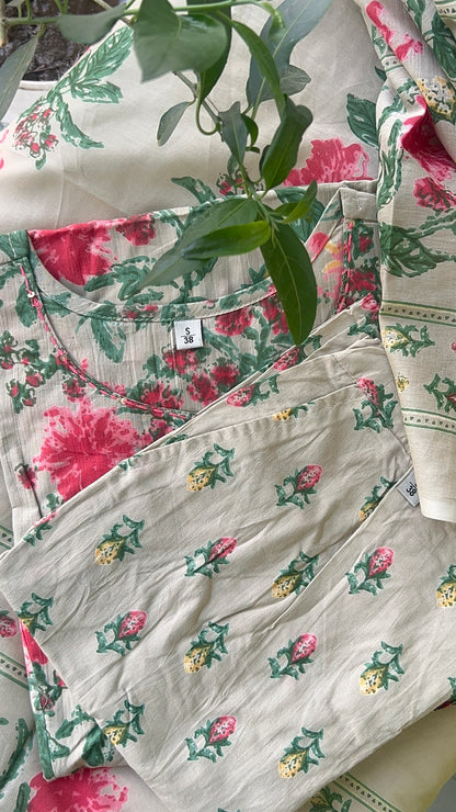 Floral patterned fabric with a visible brand label on a floral background